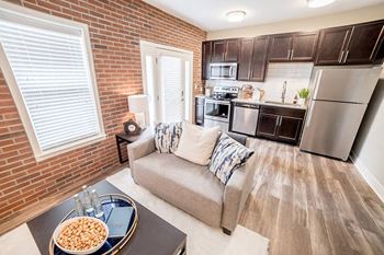 a living room and kitchen with a couch and a table at The Foundry, South Bend, 46617